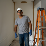 A happy homeowner admiring a freshly painted wall in their New York home.